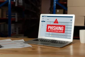 A laptop with phising text warning visible on screen